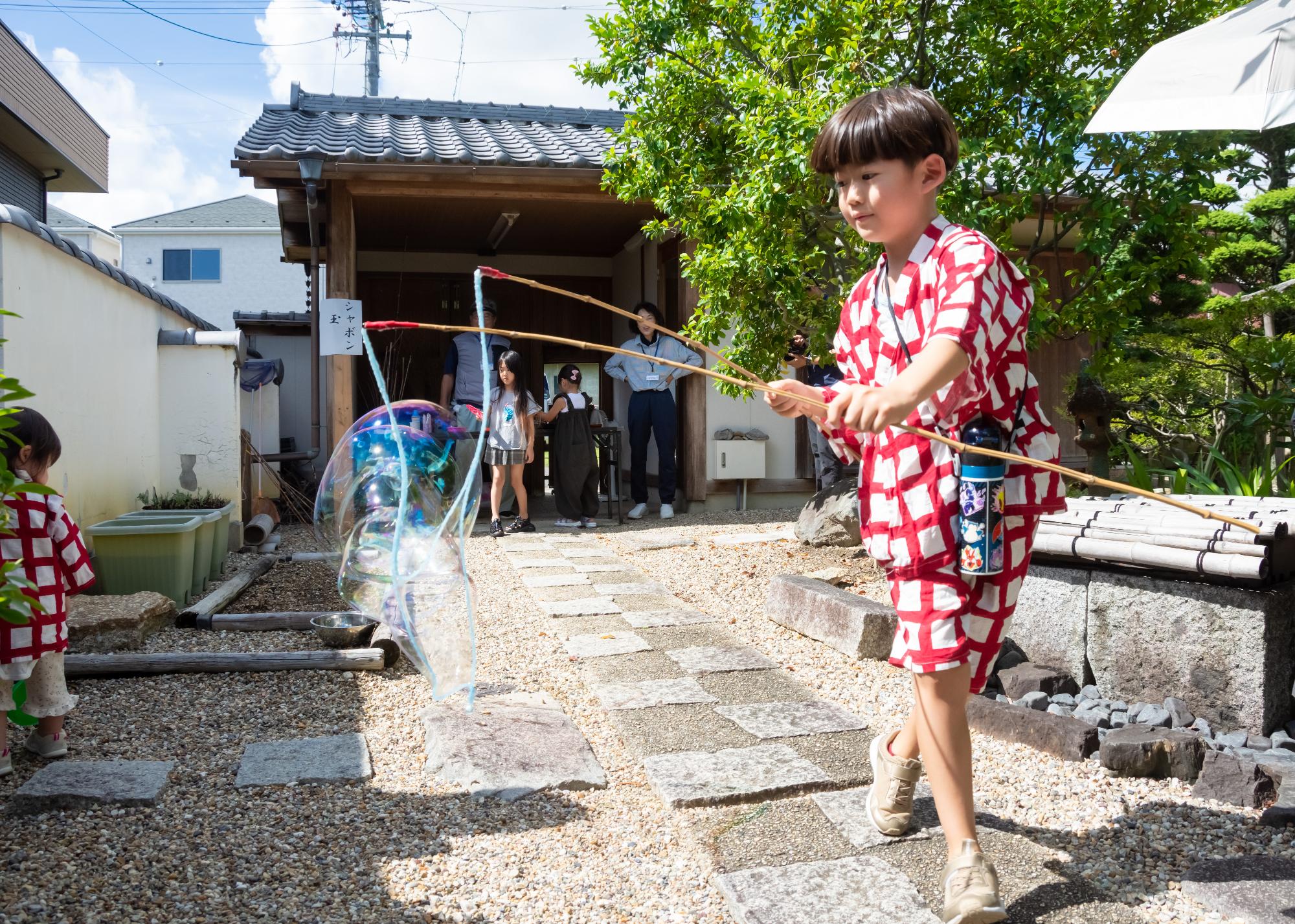 大きなシャボン玉ができるかな?シャボン玉体験の様子